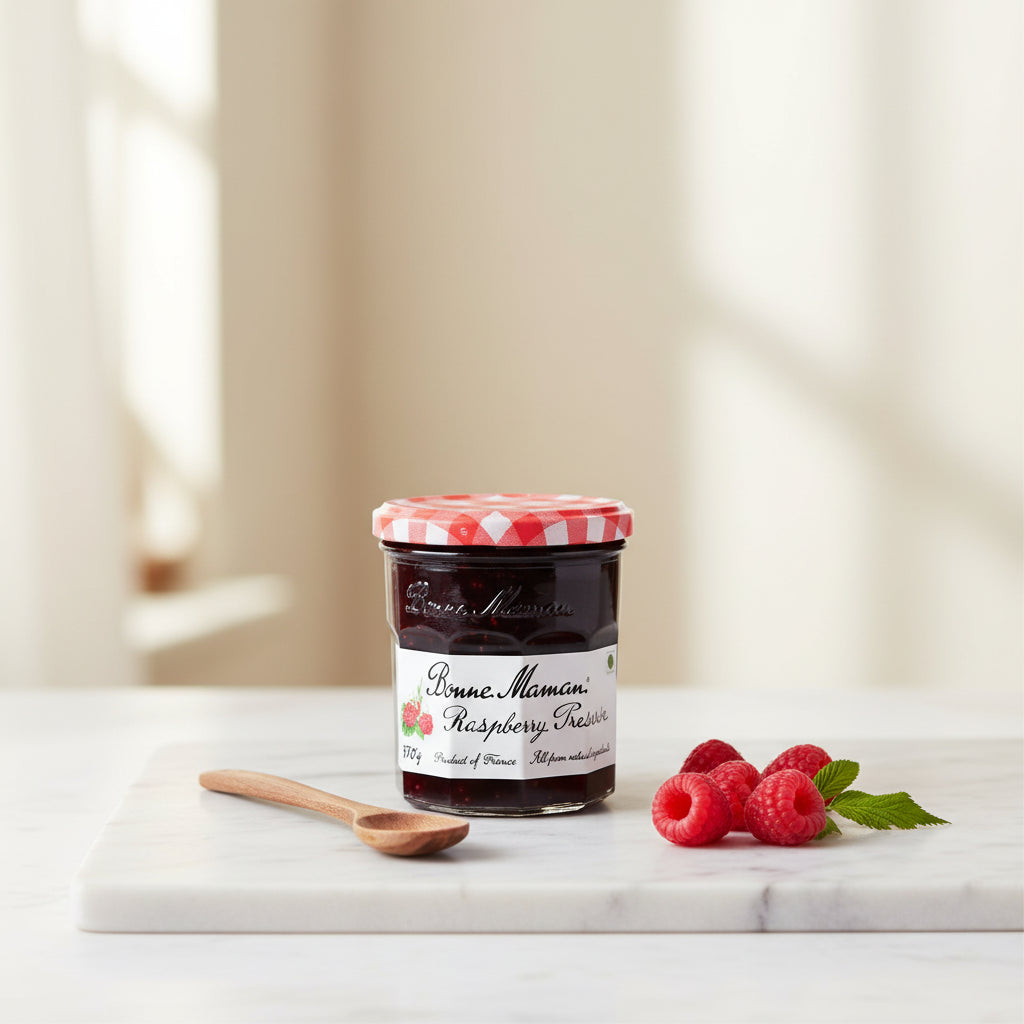 ar of Bonne Maman Raspberry Preserve with a red checkered lid on a white background