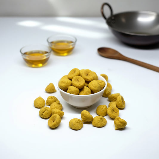 Yellow dog treats on a white plate and scattered on a white background