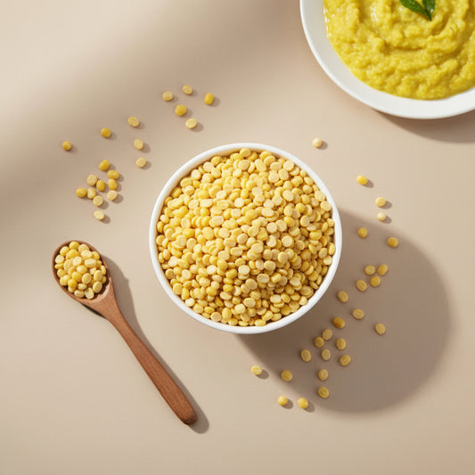 Yellow lentils in a bowl on a gray background